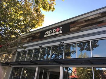 the front of a building with a red dot sign